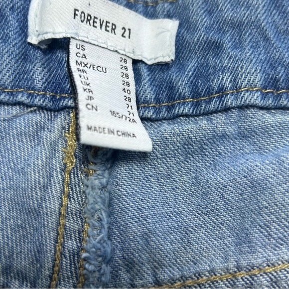 Forever21 denim blue jeans with grommets and chains on each side. - Picture 3 of 6